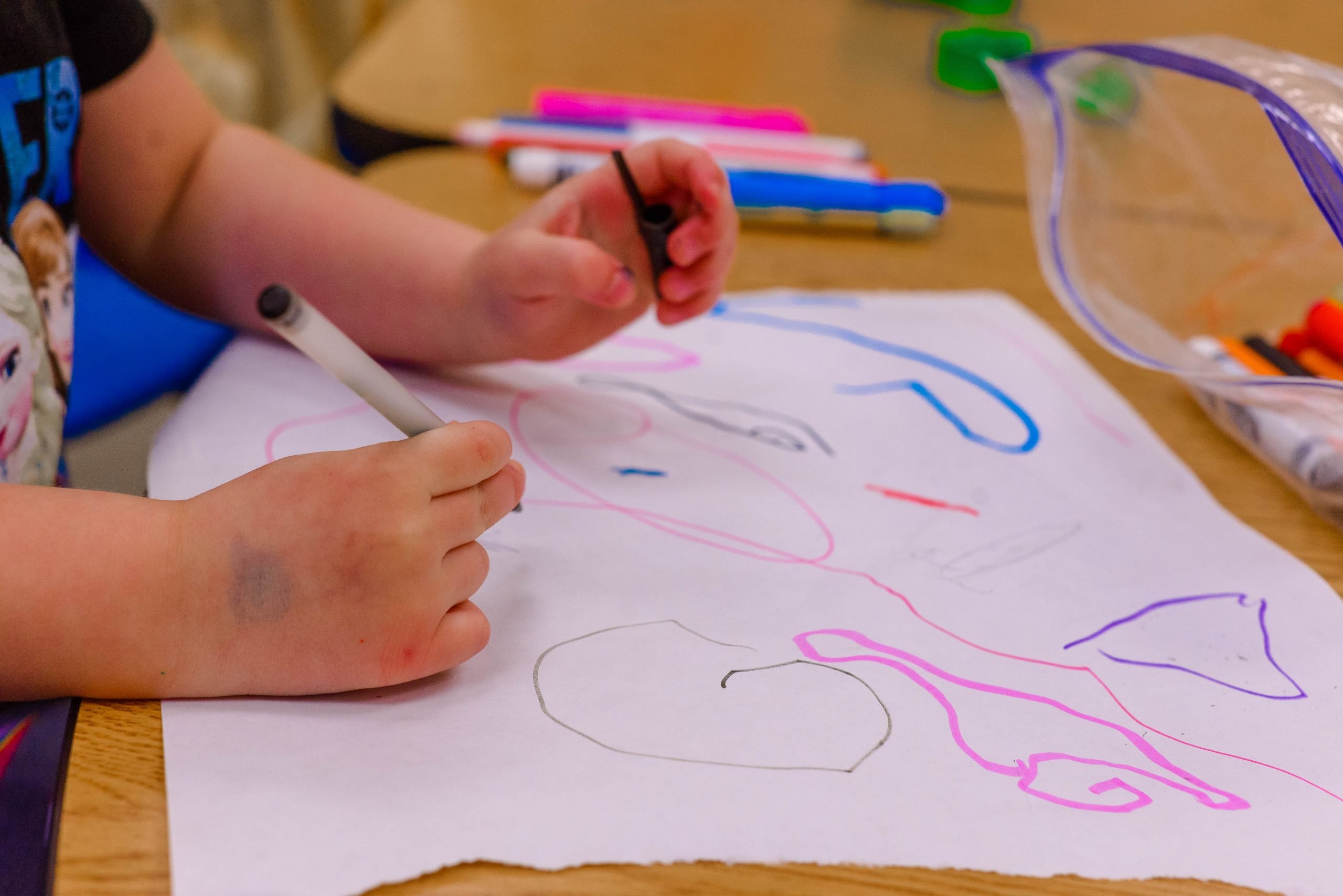 a person drawing on a paper