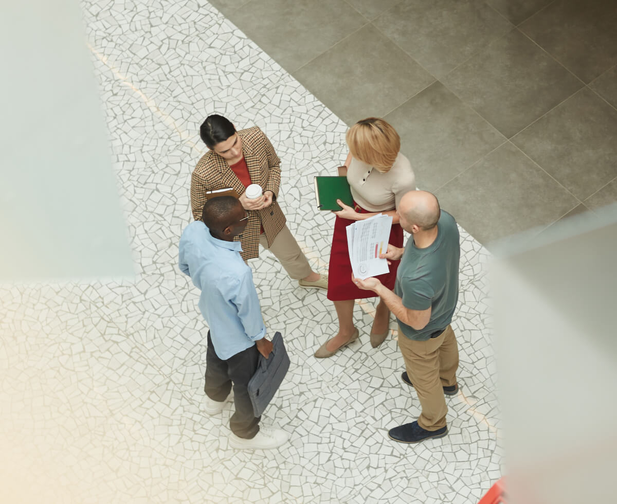 a group of people looking at a paper
