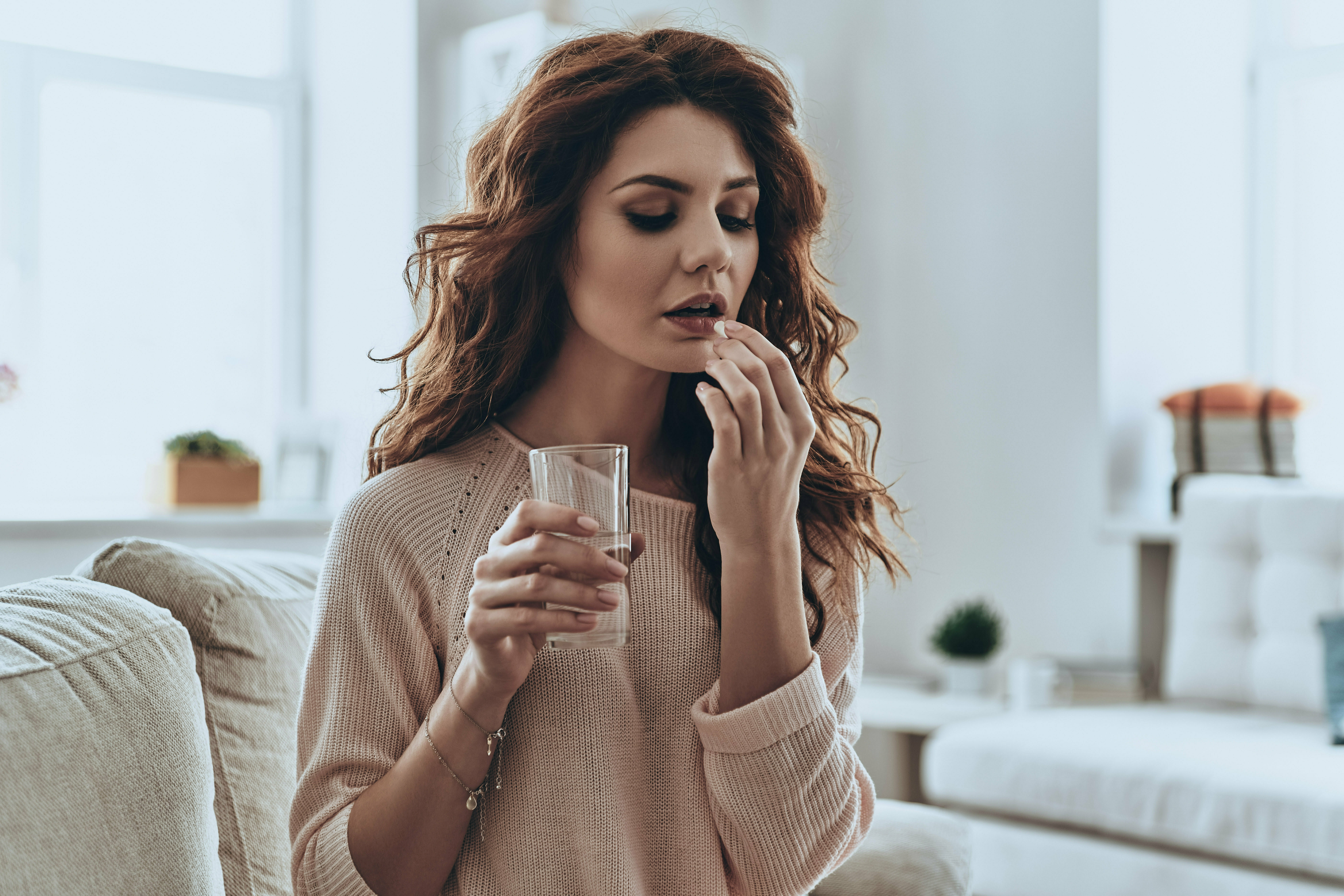 a woman holding a glass of water